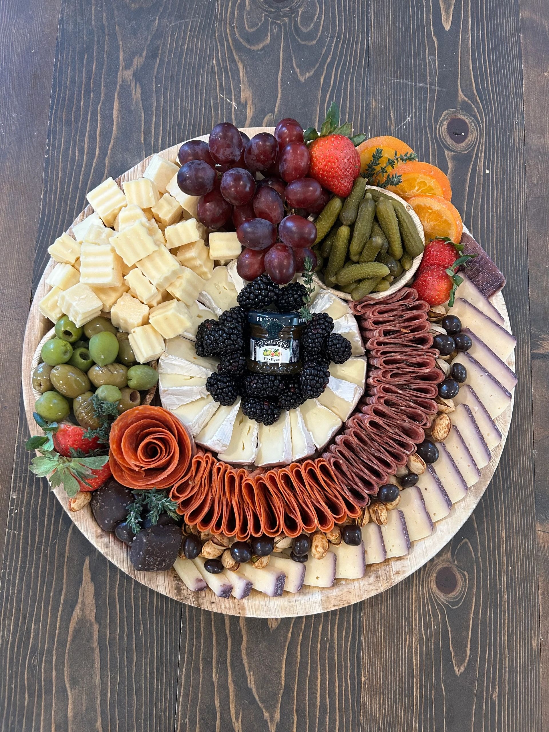 Charcuterie board with flowers and meats