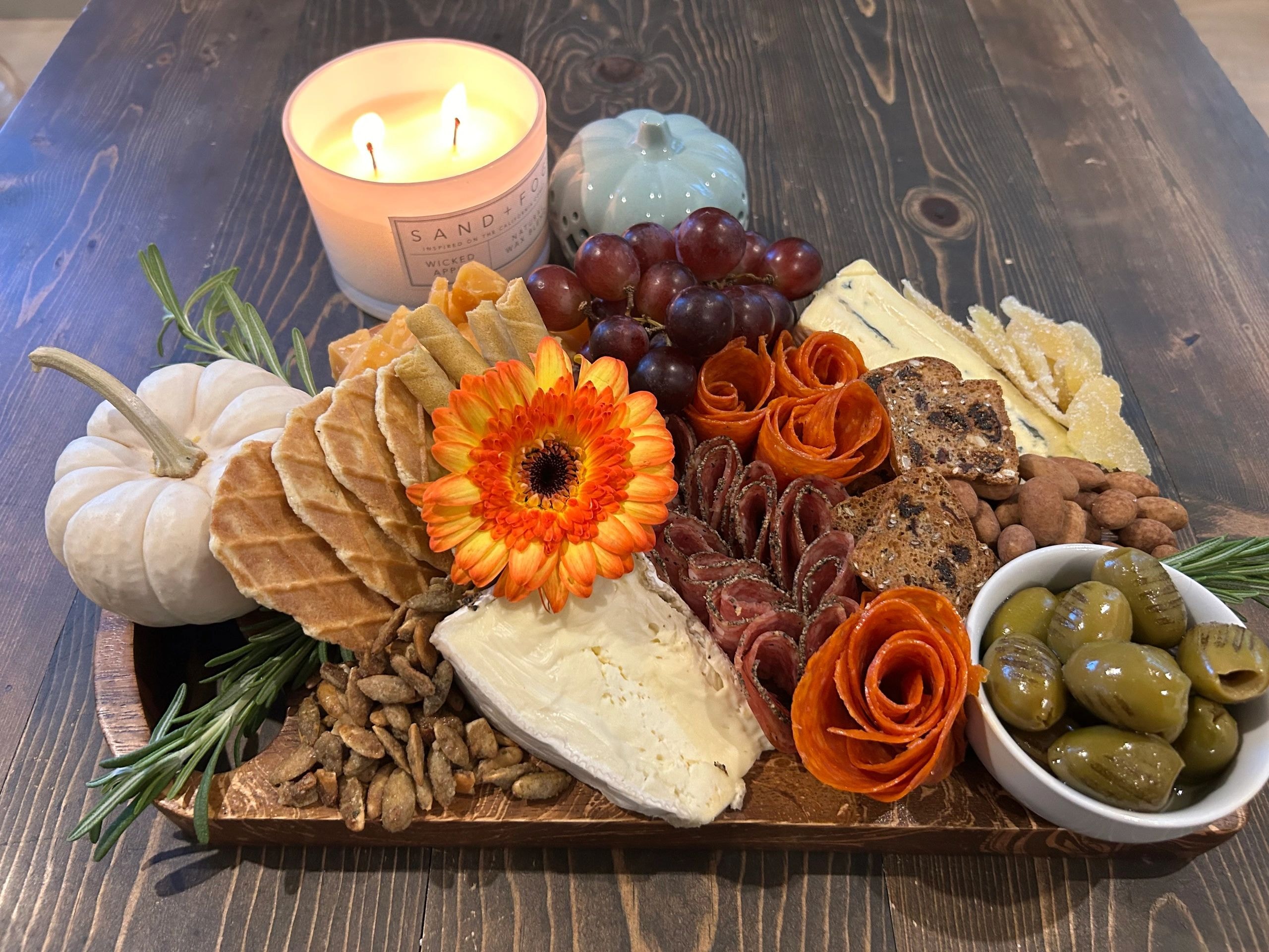 Circular charcuterie board on wooden platter